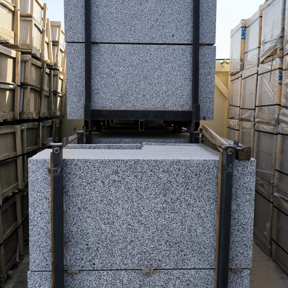 Grey Sardo Granite - Lazulite Marble Close-up of Grey Sardo granite showing a uniform grey, black, and white speckled granular pattern.